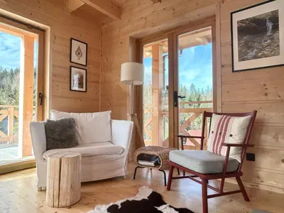 a living room with a couch and a chair at Babiogórskie klimaty in Zawoja
