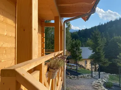 a porch of a log cabin with a view at Babiogórskie klimaty in Zawoja