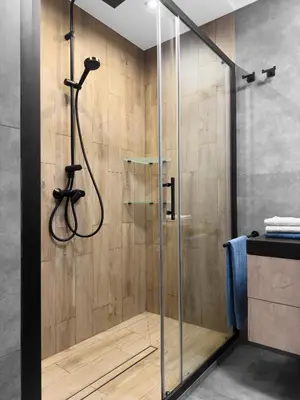 a shower with a glass door in a bathroom at Industro Art Zablocie - Balcony - WiFi 1GB - 55