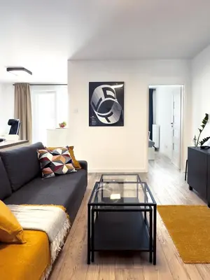 a living room with a couch and a glass table at Industro Art Zablocie - Balcony - WiFi 1GB - 55