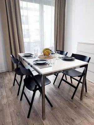 a dining room table with chairs and a plate of fruit at Industro Art Zablocie - Balcony - WiFi 1GB - 55