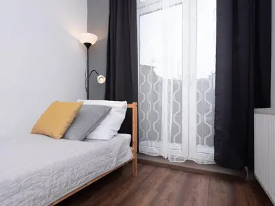 a bedroom with a bed with a green blanket and a window at Dietla 57, two-bedroom apartment with living room, apartment 24 , Ulysses in Kraków