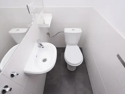 a white bathroom with a toilet and a sink at Dietla 57, two-bedroom apartment with living room, apartment 24 , Ulysses in Kraków