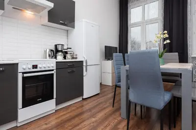 a kitchen with a table and a stove top oven at Dietla 57, two-bedroom apartment with living room, apartment 24 , Ulysses in Kraków
