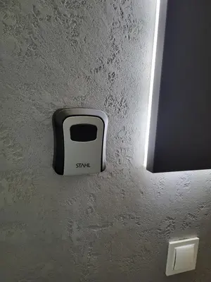 a soap dispenser on the wall of a bathroom at Apartament DeLuxe 4 in Oświęcim