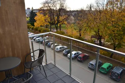 a balcony with cars parked in a parking lot at Apartament DeLuxe 4 in Oświęcim