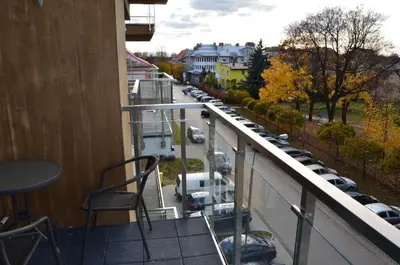 a balcony with chairs and a view of a parking lot at Apartament DeLuxe 4 in Oświęcim