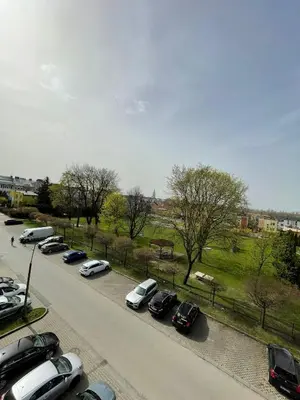 a row of parked cars in a parking lot at Apartament DeLuxe 4 in Oświęcim