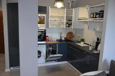 a kitchen with a washer and a washing machine at Apartament DeLuxe 4 in Oświęcim