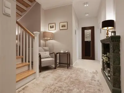 a hallway with a stairway with a chair and a fireplace at AVANTI Home in Kraków