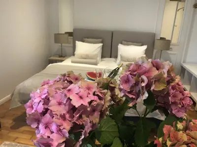 a bedroom with a bed with purple flowers on it at AVANTI Home in Kraków