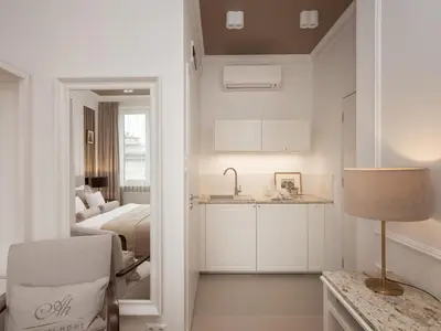 a kitchen and a bedroom with a bed and a table at AVANTI Home in Kraków