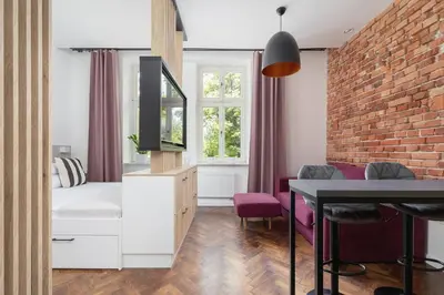 a bedroom with a bed and a brick wall at Kazimierz Area - Dietla 21 street in Kraków