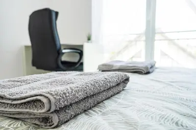 two towels are sitting on a bed in a room at Dom na Białych Brzóz pod Krakowem in Zabierzów