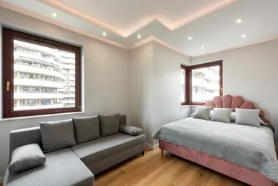a bedroom with a bed and a couch at ROYAL Deluxe 2 rooms 6 persons Aquapark Down Town in Kraków
