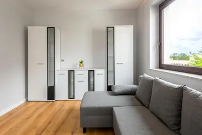 a living room with a couch and a window at ROYAL Deluxe 2 rooms 6 persons Aquapark Down Town in Kraków