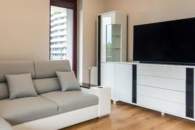 a living room with a couch and a flat screen tv at ROYAL Deluxe 2 rooms 6 persons Aquapark Down Town in Kraków