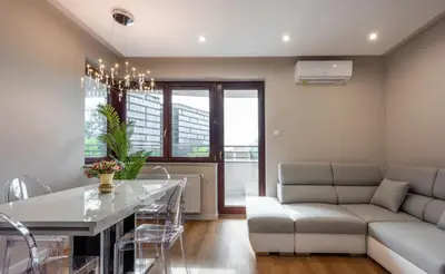 a living room with a couch and a table at ROYAL Deluxe 2 rooms 6 persons Aquapark Down Town in Kraków