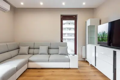 a living room with a couch and a flat screen tv at ROYAL Deluxe 2 rooms 6 persons Aquapark Down Town in Kraków