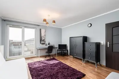 a living room with a desk and a window at Podgórze Standard Studio by BookingHost in Kraków