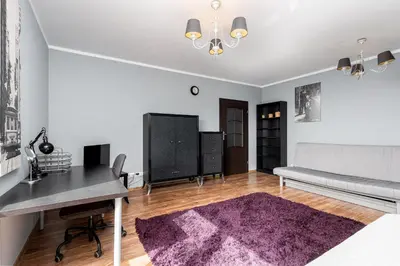 a living room with a bed and a desk at Podgórze Standard Studio by BookingHost in Kraków