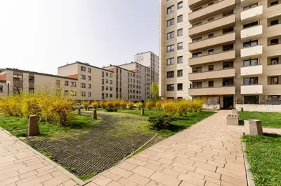 a park in the middle of a city with buildings at Podgórze Standard Studio by BookingHost in Kraków