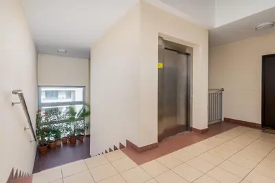 a hallway with an elevator in a building at Podgórze Standard Studio by BookingHost in Kraków