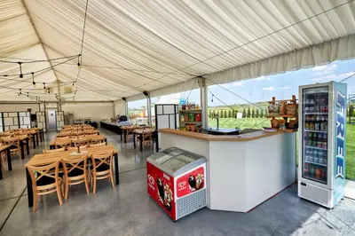 a restaurant with tables and chairs and a bar at Fantazja Resort Zator in Zator