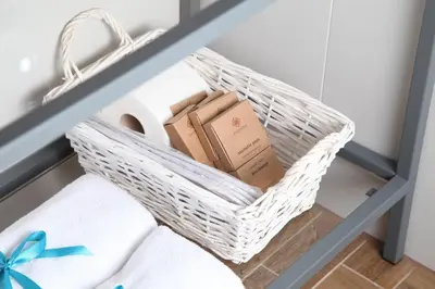 a basket sitting on top of a bed with towels at Tomasza 26 Old Town Suites in Kraków