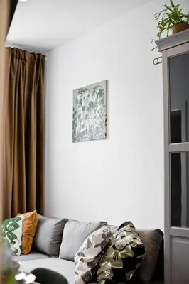 a living room with a couch and a picture on the wall at Balaton Apartamenty in Trzebinia