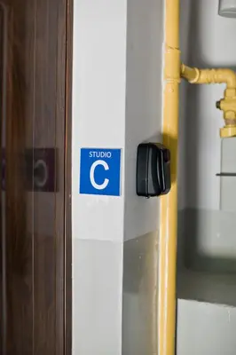 a sign on the side of a building with a c on it at Balaton Apartamenty in Trzebinia