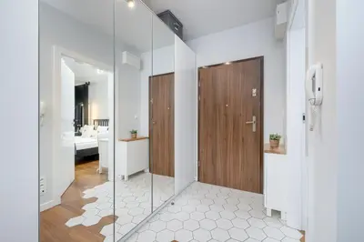 a bathroom with white walls and a glass door at Ślusarska Modern Apartment with Balcony & Parking Cracow Zabłocie by Renters Prestige in Kraków