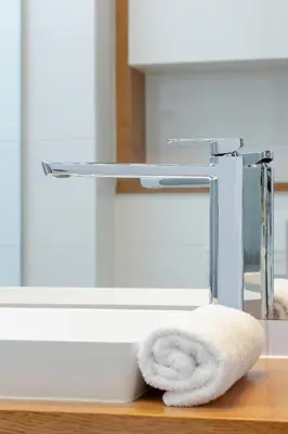 a towel sitting on a counter next to a sink at Ślusarska Modern Apartment with Balcony & Parking Cracow Zabłocie by Renters Prestige in Kraków