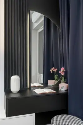 a bathroom with a vanity with a mirror and flowers at Ślusarska Modern Apartment with Balcony & Parking Cracow Zabłocie by Renters Prestige in Kraków