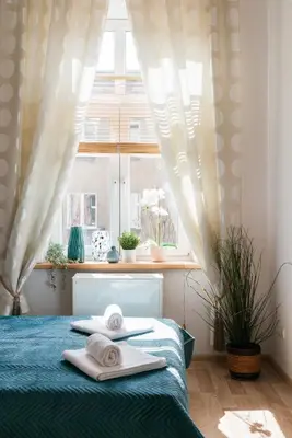 a bedroom with a bed with towels on it at Krowoderska 39 in Kraków