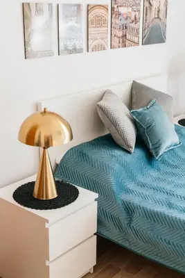 a bedroom with a bed and a lamp on a nightstand at Krowoderska 39 in Kraków