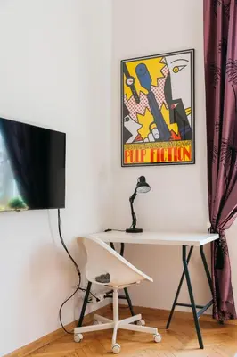 a room with a desk and a tv and a chair at Krowoderska 39 in Kraków
