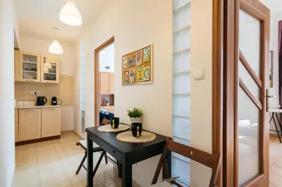 a kitchen and dining room with a table and chairs at Krowoderska 39 in Kraków