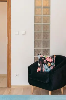a black couch with a pillow on it in a room at Krowoderska 39 in Kraków