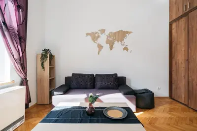 a living room with a couch and a world map on the wall at Krowoderska 39 in Kraków