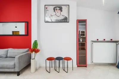 a living room with a couch and two stools at Unique Spacious 3 Bedroom Apartment - Old Town Loft - by Upstairs in Kraków