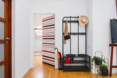 a hallway with a black and white striped wall at Unique Spacious 3 Bedroom Apartment - Old Town Loft - by Upstairs in Kraków