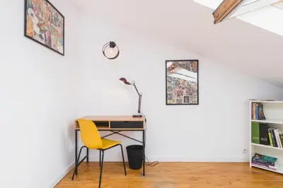 a desk in a room with a yellow chair at Unique Spacious 3 Bedroom Apartment - Old Town Loft - by Upstairs in Kraków