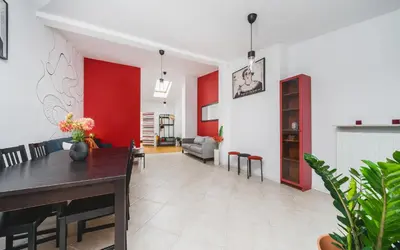 a dining room and living room with red walls at Unique Spacious 3 Bedroom Apartment - Old Town Loft - by Upstairs in Kraków