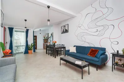 a living room with a blue couch and a table at Unique Spacious 3 Bedroom Apartment - Old Town Loft - by Upstairs in Kraków