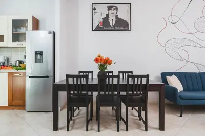 a dining room with a table and a refrigerator at Unique Spacious 3 Bedroom Apartment - Old Town Loft - by Upstairs in Kraków