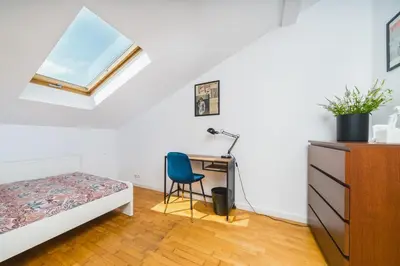 a bedroom with a bed desk and a window at Unique Spacious 3 Bedroom Apartment - Old Town Loft - by Upstairs in Kraków