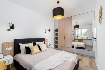 a bedroom with a large bed and a mirror at Royal Center Apartments in Kraków