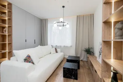 a living room with a white couch and a table at Royal Center Apartments in Kraków