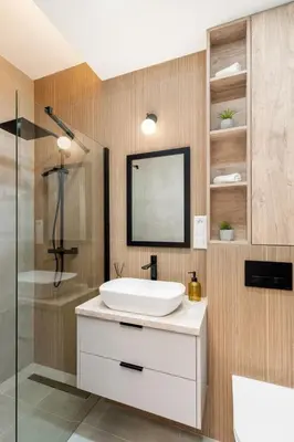 a bathroom with a white sink and a shower at Royal Center Apartments in Kraków